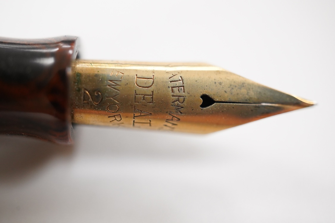 A Waterman Red Ripple No. 5 lever fitted with red cap band and filled with No.2 Waterman nib